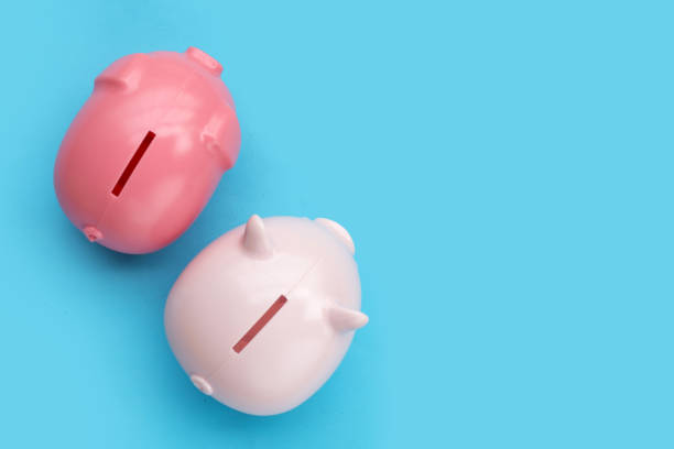 istock Pink piggy bank on blue background. 1394165603