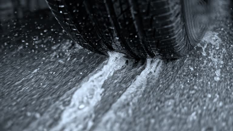 SLO MO TS Tire of a car breaking hard sliding on an asphalt road