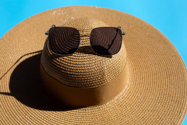 istock Summer hat with sunglasses on blue background. Enjoy holiday concept. 1394165890