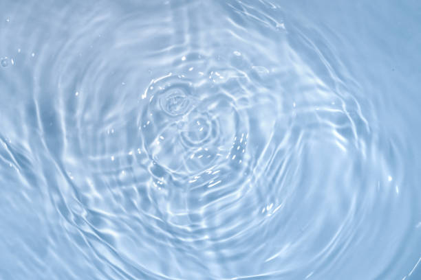 istock Circles on water. Blue round shadows. Blurred background made with water and light in monochrome. 1394165921