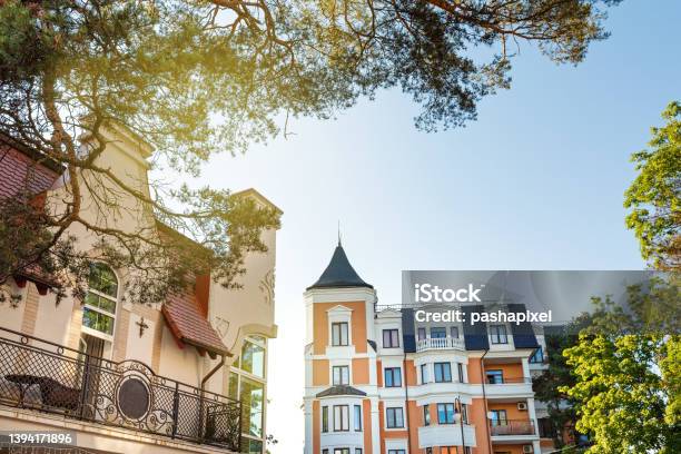 Crop Of Building Facade With Windows And Roof At Sunny Day Stock Photo - Download Image Now