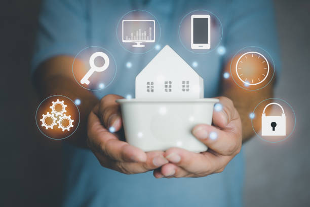 istock Hands holding small house with icons controlled around. 1394174881