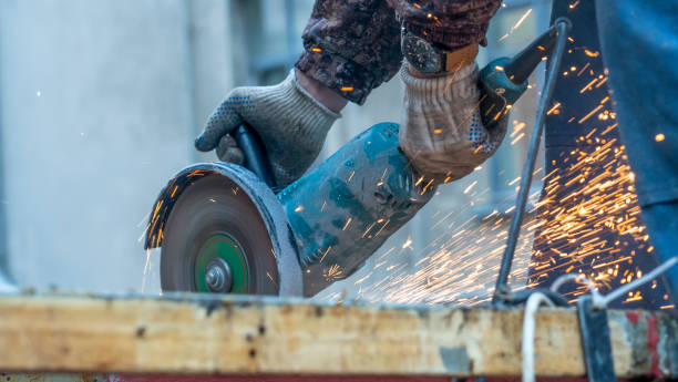 istock Worker working with angle grinder. Electric wheel grinding on steel structure. Sparks. Defocused foreground. 1394178530