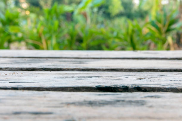 istock old wood table with blurred green background. 1394178594