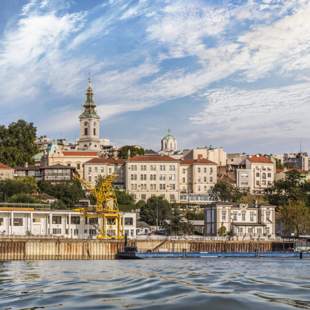 Belgrade Tourist Nautical Harbour, with Port Authorities Headquarters, Old Port Depot and Downtown Skyline with the Church of St. Michael Bell Tower, viewed from Sava River perspective.