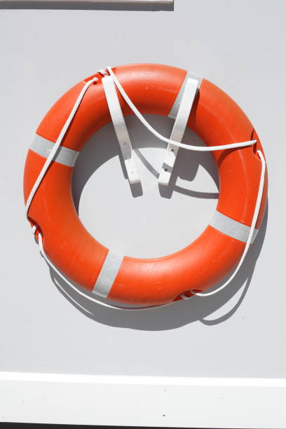 istock Red lifebuoy on a white ship wall, Germany 1394183110