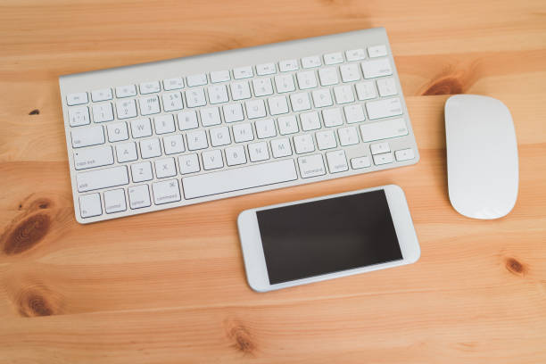 istock Wireless aluminum keyboard, computer mouse and smartphone. 1394193763