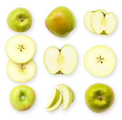 Set of fresh whole and sliced green apples on a white background. Golden apple
