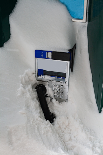 Street phone completely covered with snow after strong storm in Quebec city