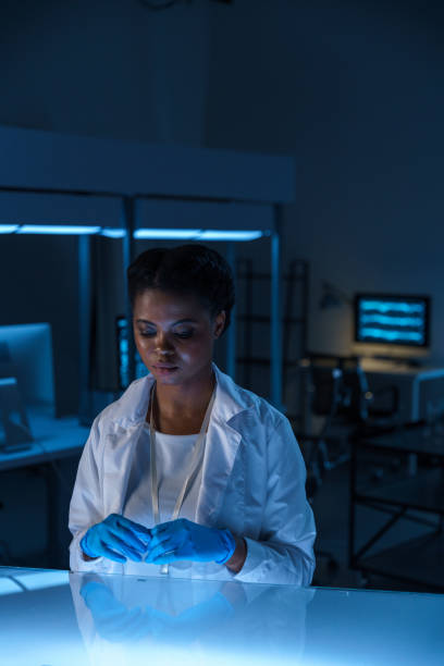 istock A young beautiful African-American lab assistant working late in a modern laboratory 1394199167