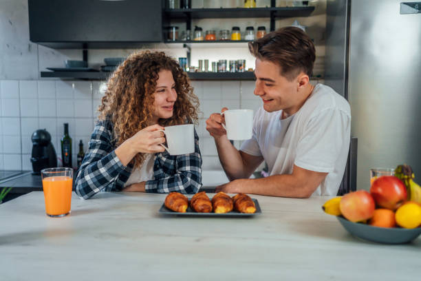 istock Couple at home drinking coffee together 1394202290