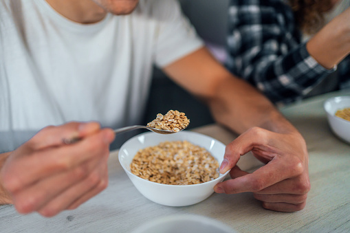 Man eating cereals for breakfast at home