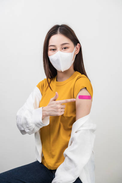 portrait photo young attractive beautiful asian woman wear face mask receive covid-19 antivirus vaccine safe life protect virus infection people healthcare social issue concept. - immune defence fotos imagens e fotografias de stock