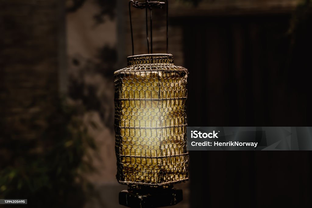 Vintage oriental wire mesh lamp in lighting up a room. Ancient Stock Photo