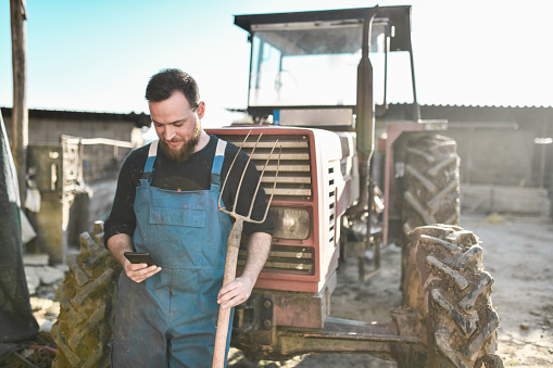 Modern Farmer Using Smartphone To Promote His Farming Products
