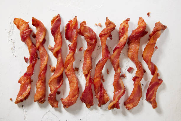 Spiraled Thick Cut Bacon Spiraled Thick Cut Bacon Made Famous on Social Media cooked bacon slice stock pictures, royalty-free photos & images