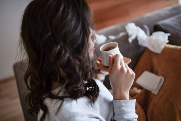 istock Female Suffering From Flu And Drinking Tea At Home 1394211698