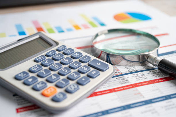 istock Magnifying glass and calculator on charts graphs paper. Financial development, Banking Account, Statistics, Investment Analytic research data economy, Stock exchange trading, Business office concept. 1394213697