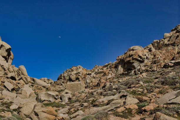 istock Moon Valley with rocks and small house and Moon 1394216683