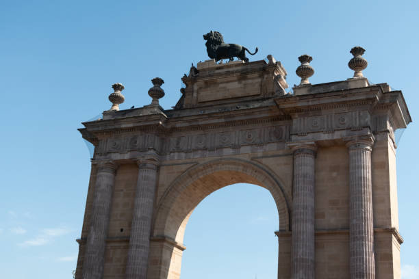 Guanajuato lion arch with cement lion on top and clear blue sky