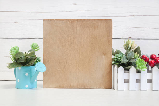 istock Wooden sign mockup on a light background with flowers 1394217174