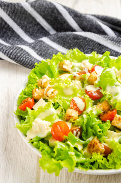 istock Lettuce, tomato and cheese salad, croutons, dressing. 1394219222