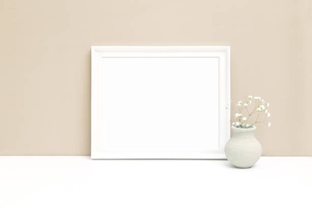 istock White horizontal wooden frame mockup with small vase and white flower 1394219321