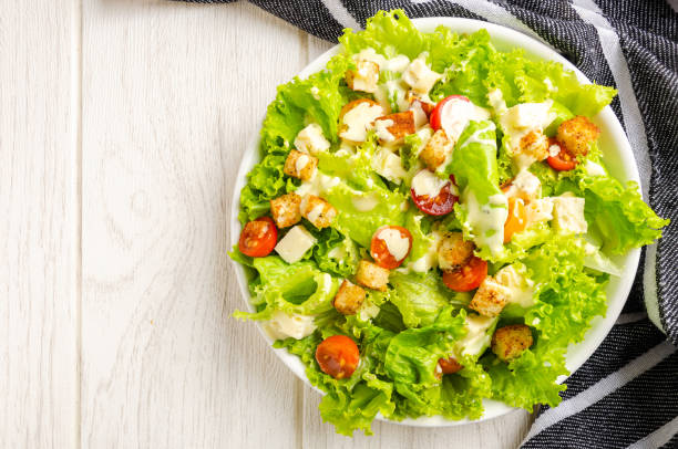 istock Lettuce, tomato and cheese salad, croutons, dressing. 1394219347