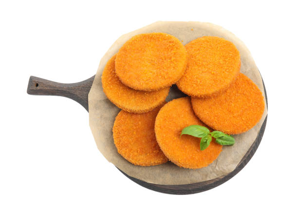 istock Delicious fried breaded cutlets with basil leaves isolated on white, top view 1394220183