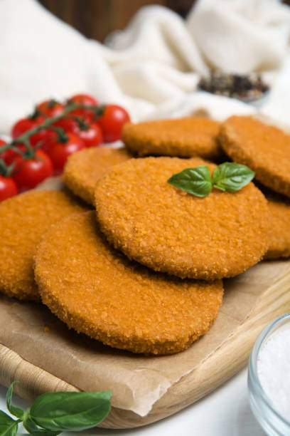 istock Delicious fried breaded cutlets served on white table, closeup 1394222866