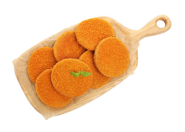 istock Delicious fried breaded cutlets with basil leaves isolated on white, top view 1394224015