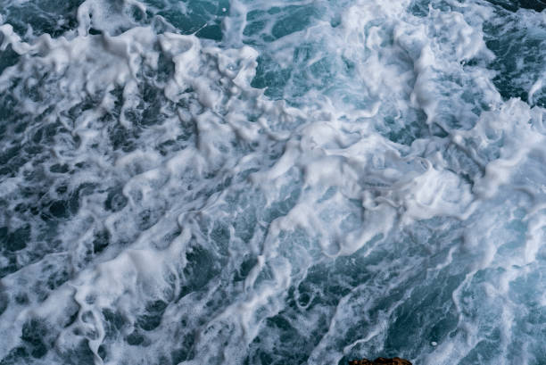 istock Sea water waves and white foam. 1394225249