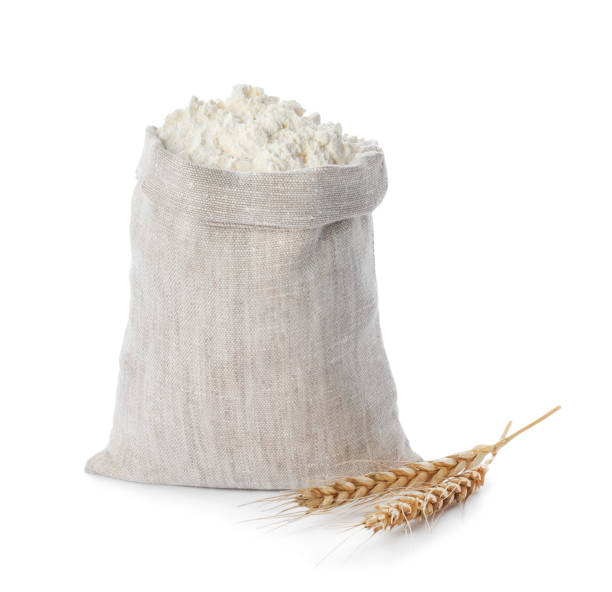 istock Sack with flour and wheat spikes on white background 1394225840