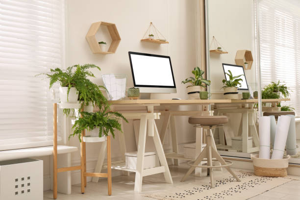istock Comfortable workplace with modern computer and houseplants in room. Interior design 1394226029