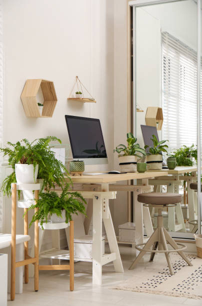istock Comfortable workplace with modern computer and houseplants in room. Interior design 1394226052