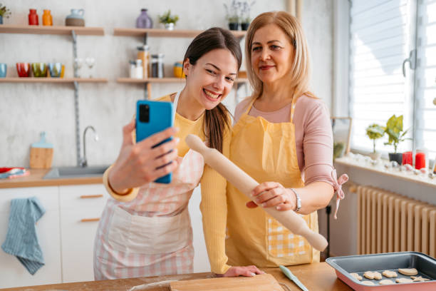 istock Mother And Daughter Taking A Selfie While Baking In The Kitchen 1394226134