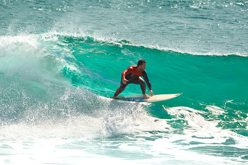 view out of a barrel with a surfer on the shoulder of a wave