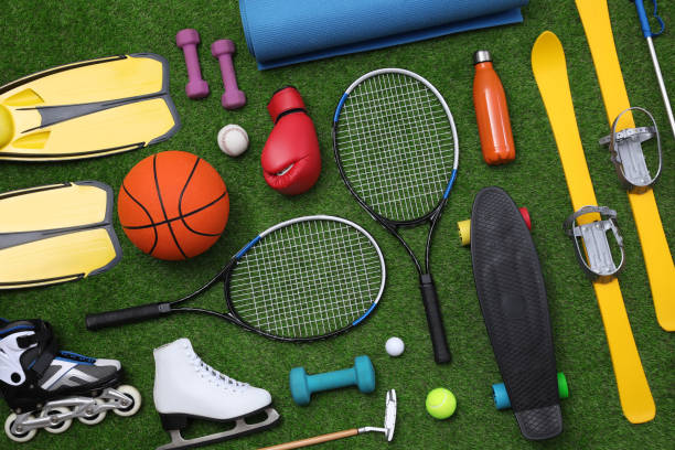 istock Different sport equipment on green grass, flat lay 1394227993