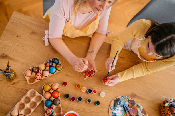 istock Mother And A Daughter Painting Easter Eggs 1394228042