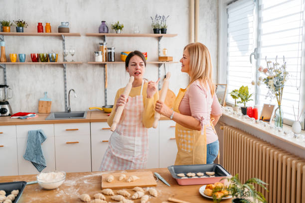 istock Mother And Daughter Singing And Dancing While Baking In The Kitchen 1394228252