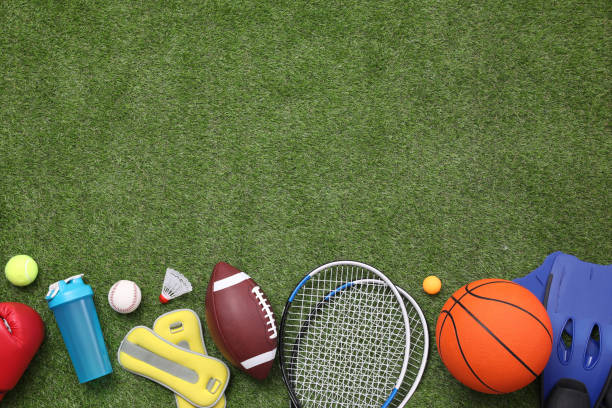 istock Different sport equipment on green grass, flat lay. Space for text 1394228351