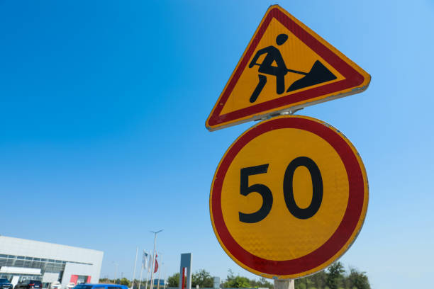 istock Road construction and speed limit signs outdoors on sunny day. Repair works 1394228357