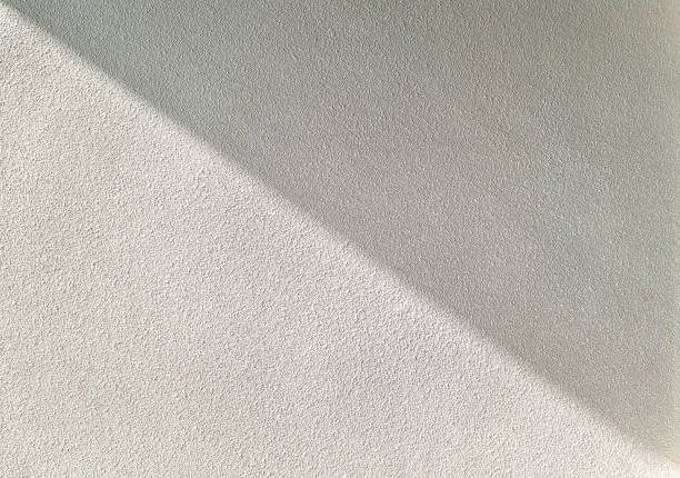 istock rough concrete wall with natural light. abstract beige background with shadow of natural light on concrete wall. background, wallpaper, nature shadow pattern on wall. copy space for design. 1394228431