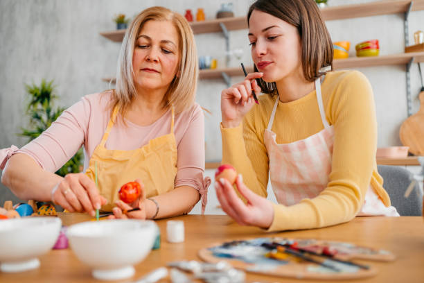 istock Mother And A Daughter Painting Easter Eggs 1394228661