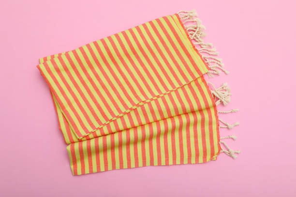 istock Folded striped beach towel on pink background, top view 1394228790