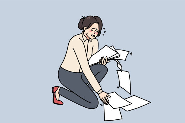 istock Clumsy businesswoman collect scattered paperwork on floor 1394228864