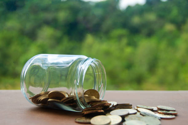 Gold coins on wooden table with blurred nature background. Gold coins on wooden table with blurred nature background. Copy space coins of ringgit of malaysia stock pictures, royalty-free photos & images