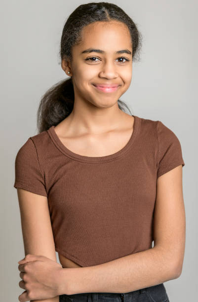 istock Beautiful black teen posing on studio gray background 1394229576