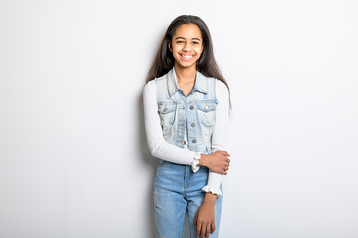 A Beautiful black teen posing on studio white background