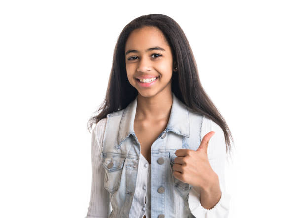 istock Beautiful black teen posing on studio white background doing positive thumb up 1394229788